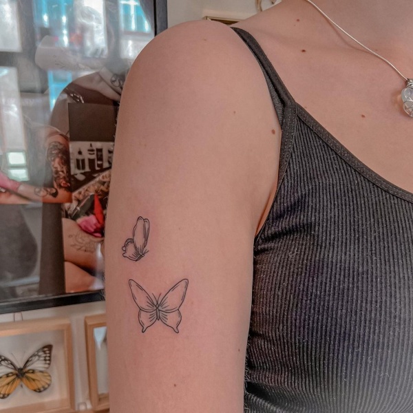 Small butterfly tattoo located on the shoulder